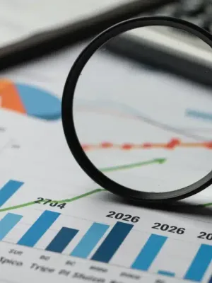 Credit score graph with magnifying glass on 2026, financial documents