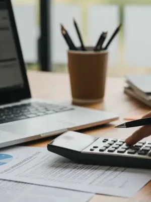 Person calculating student loan refinancing options with a 5% rate drop in 2026