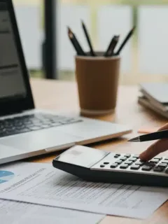 Person calculating student loan refinancing options with a 5% rate drop in 2026