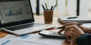 Person calculating student loan refinancing options with a 5% rate drop in 2026